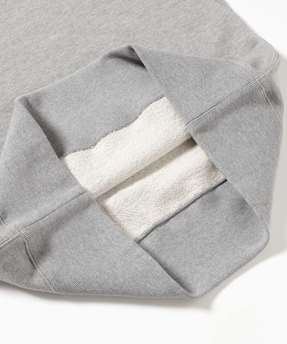 Close view of a French terry sweatshirt turned back to show the loopback interior